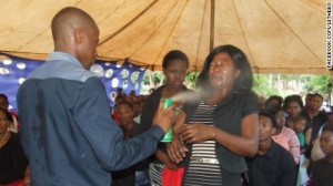 Orophet Lethebo Rabalago sprays Doom insecicide at people to "heal" them.